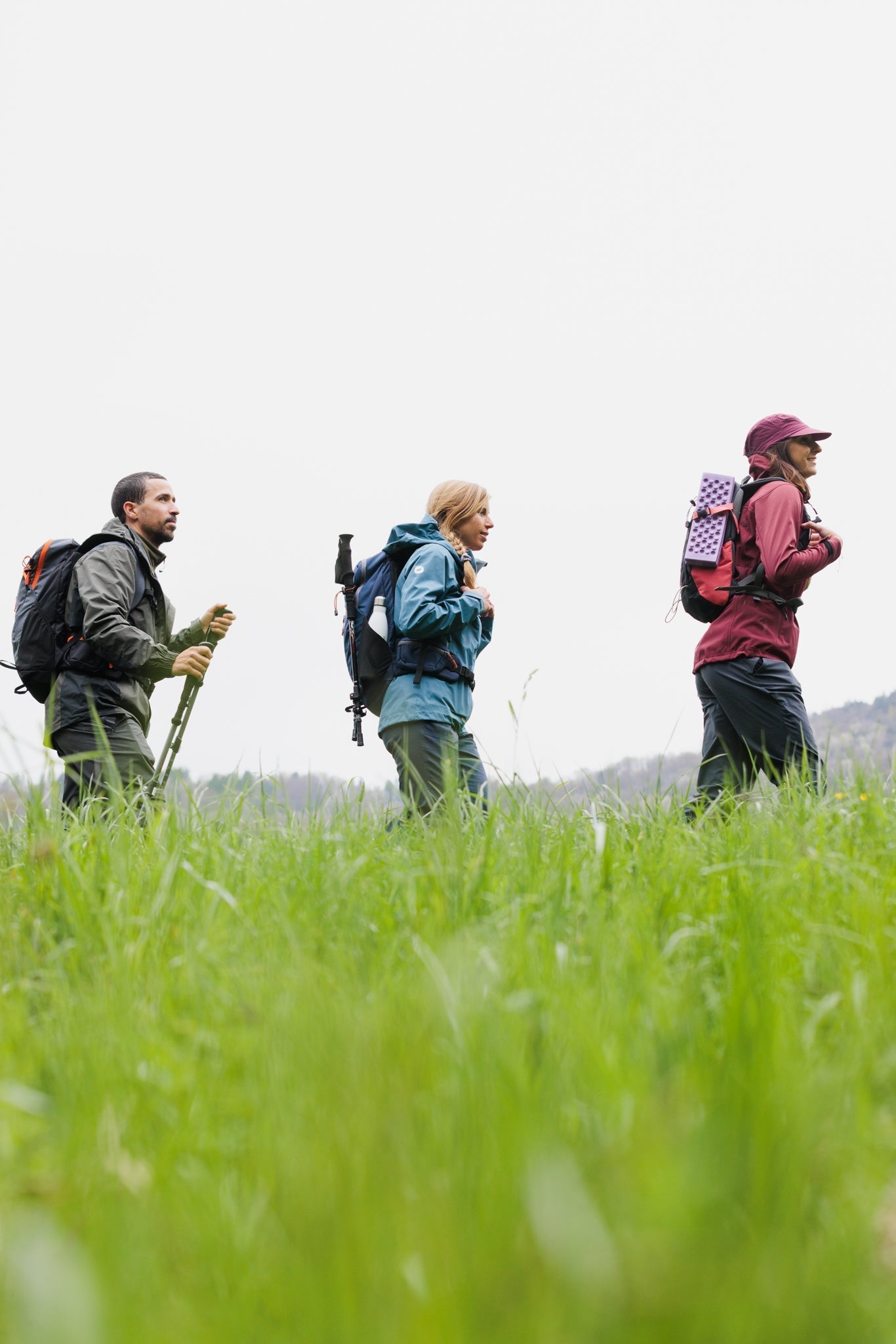 Groupe de randonneurs avec sacs à dos, bâtons de randonnée et gourde en inox
